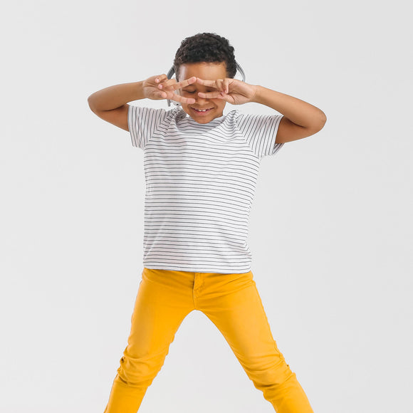 Happy young boy in yellow trousers